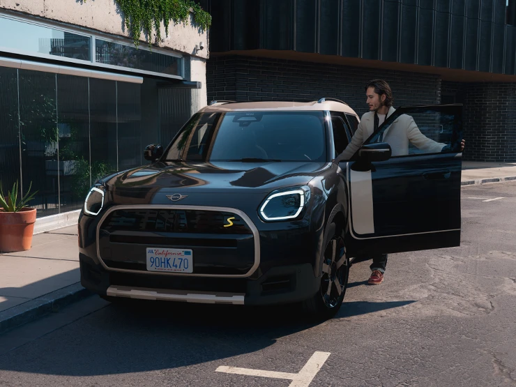 Vue avant du MINI Countryman Electric Midnight Black avec toit Vibrant Silver en ville.