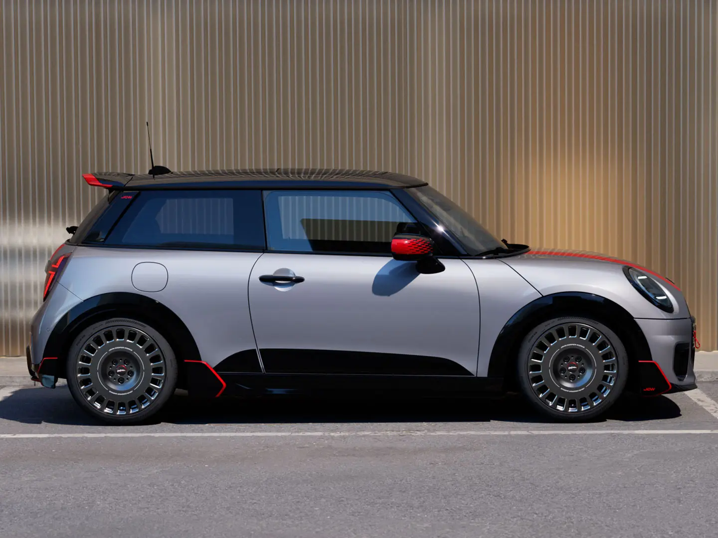 MINI Cooper 3 portes Melting Silver avec becquet de toit John Cooper Works pour des propriétés aérodynamiques améliorées, vue latérale.